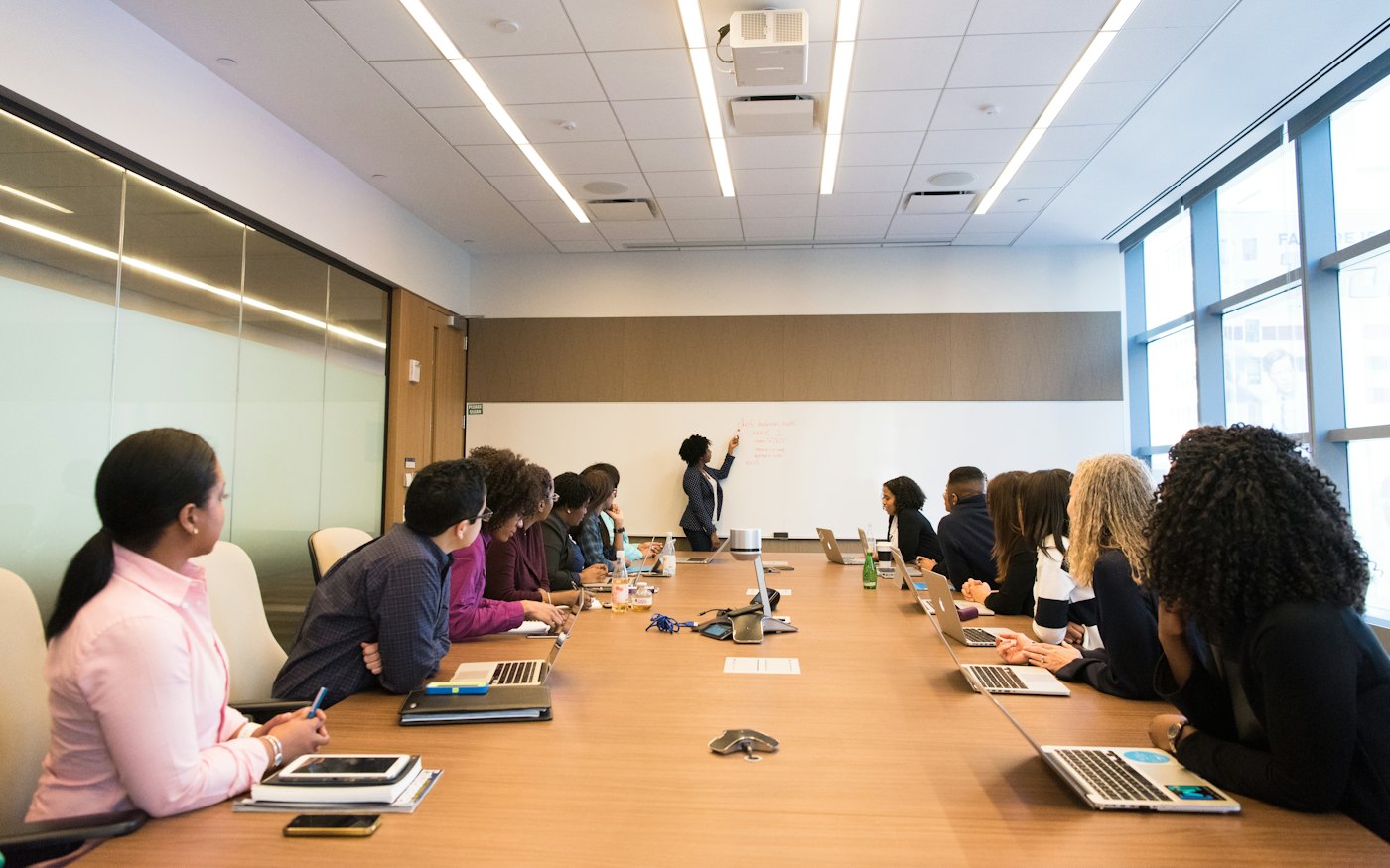 A colleague presenting to others around a meeting table